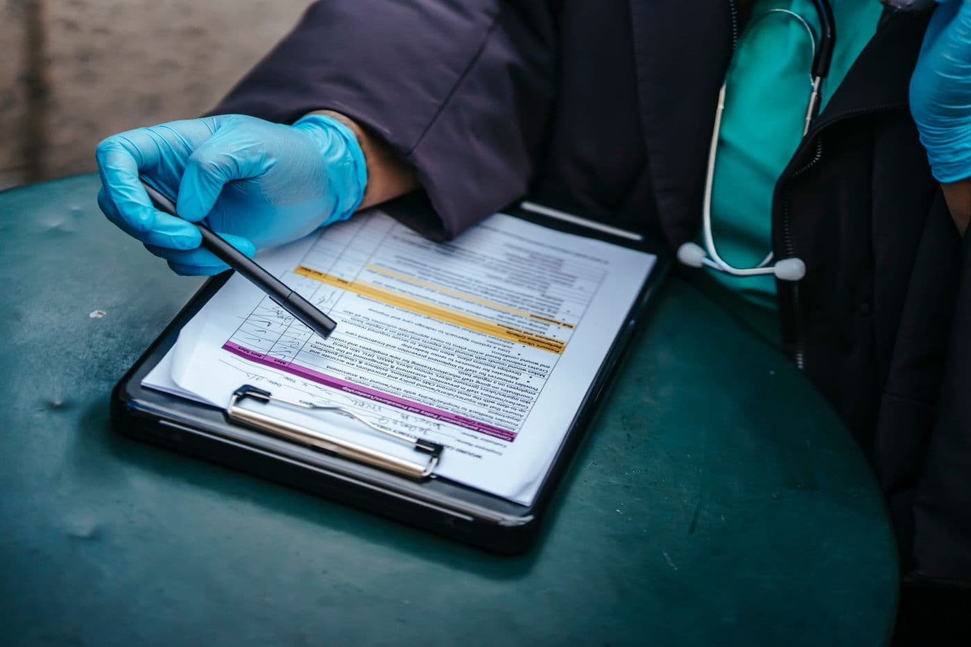 A pharmacist reviewing a prescription on a clipboard